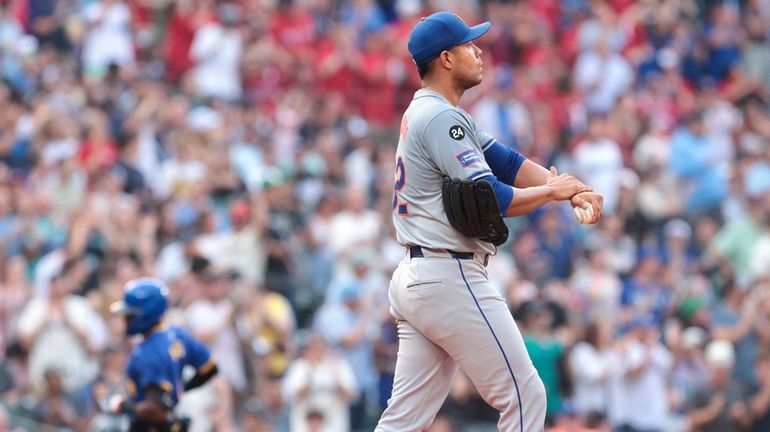 Mets starting pitcher Jose Quintana, right, walks to the mound...