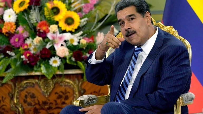 FILE -Venezuela's President Nicolas Maduro points while meeting Colombia's new...