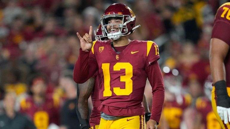 Southern California quarterback Caleb Williams (13) signals to a teammate...