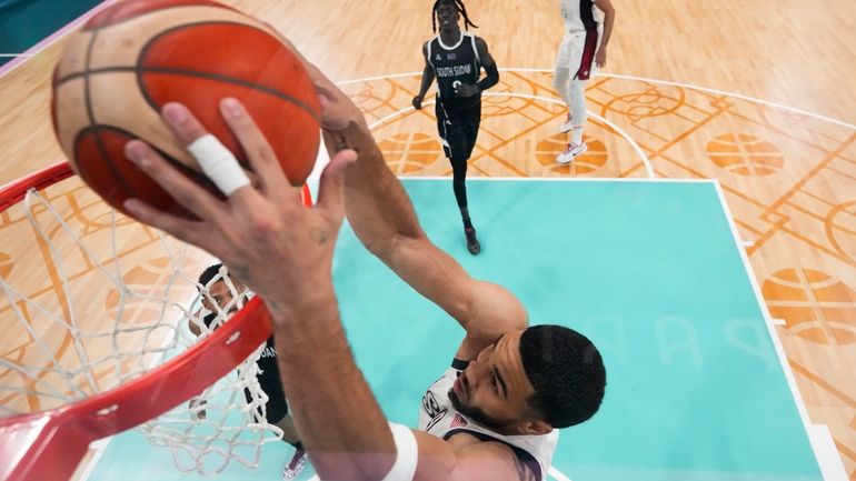 Jayson Tatum, of the United States, gets a basket on...