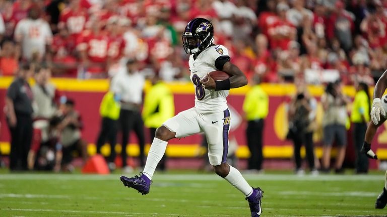 Baltimore Ravens quarterback Lamar Jackson runs with the ball during...