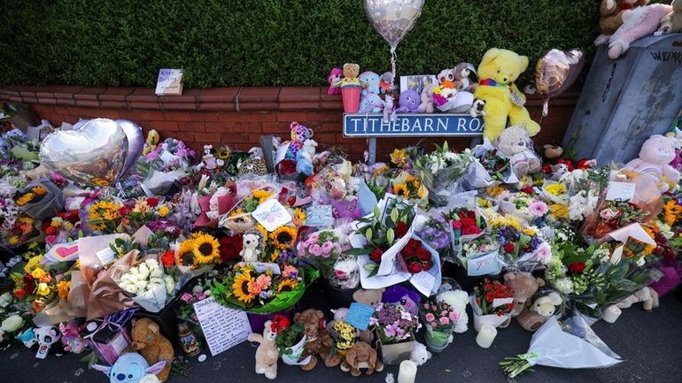 Flowers and toys are placed on the junction of Tithebarn...