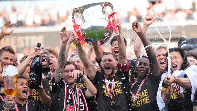 FC Midtjylland's players celebrate winning the Danish Superliga trophy at...