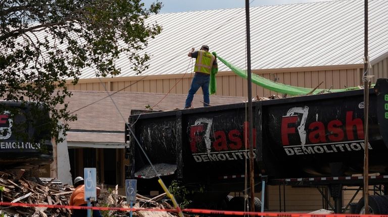 Workers begin demolition of the First Baptist Church of Sutherland...