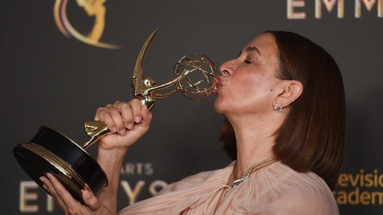 Maya Rudolph kisses her trophy for outstanding character voice-over performance...