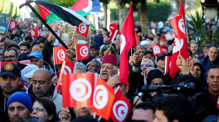 People commemorate the 13th anniversary of the Tunisian uprising in...