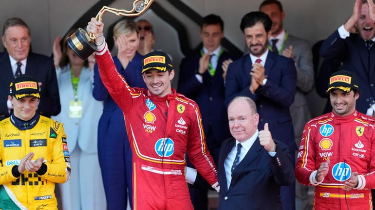 Ferrari driver Charles Leclerc of Monaco celebrates on the podium...