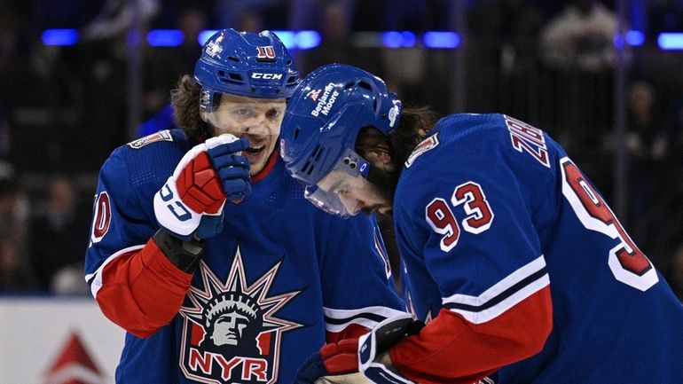 Rangers left wing Artemi Panarin talks with center Mika Zibanejad...