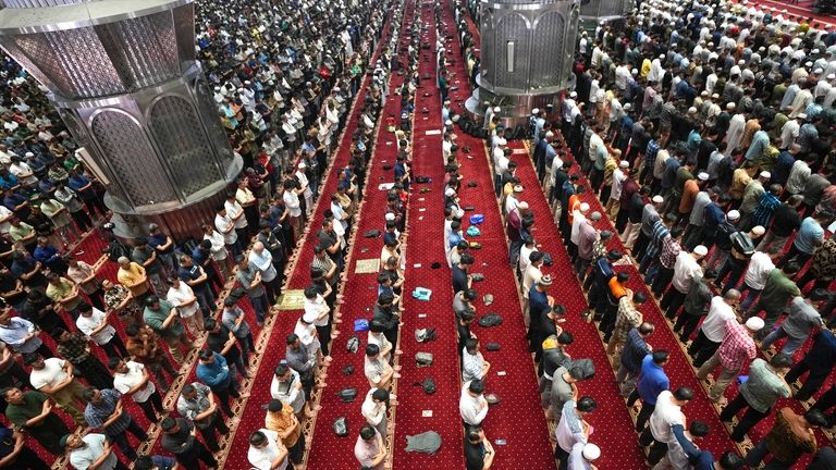 Muslim men perform Friday prayer at Istiqlal Mosque in Jakarta,...