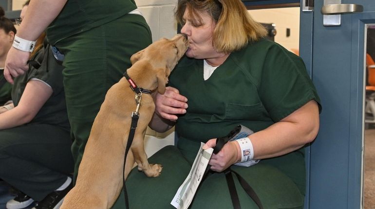 Sandra Arcarola gets a kiss from Zelda at the Yaphank Jail...