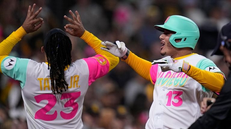 San Diego Padres' Manny Machado, right, celebrates with teammate Fernando...