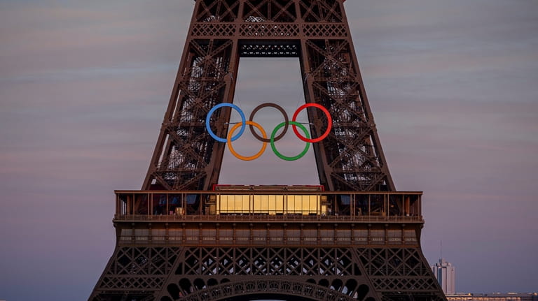 The Olympic rings are seen on the Eiffel Tower Friday,...