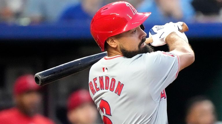 Los Angeles Angels' Anthony Rendon watches his sacrifice to score...