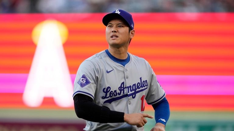 Los Angeles Dodgers' Shohei Ohtani warms up prior to a...