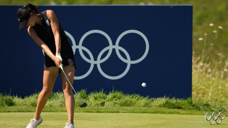 Lydia Ko, of New Zealand, hits her shot from the...