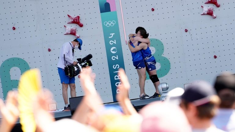 Sam Watson of the United States, left, is congratulated by...