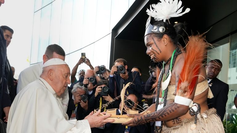 Pope Francis receives souvenir from a Papua New Guinea traditional...