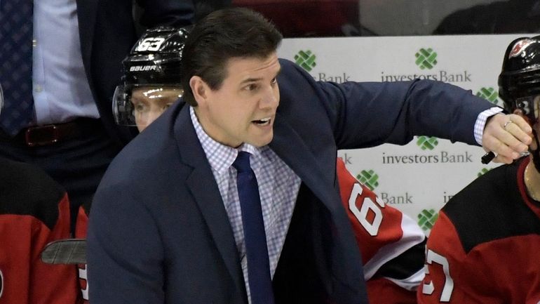 Devils assistant coach Rick Kowalsky talks to the team during...