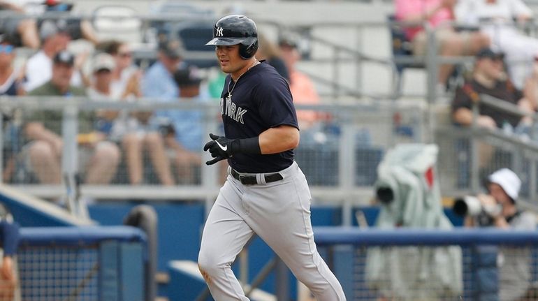 Luke Voit #45 of the Yankees rounds the bases after...