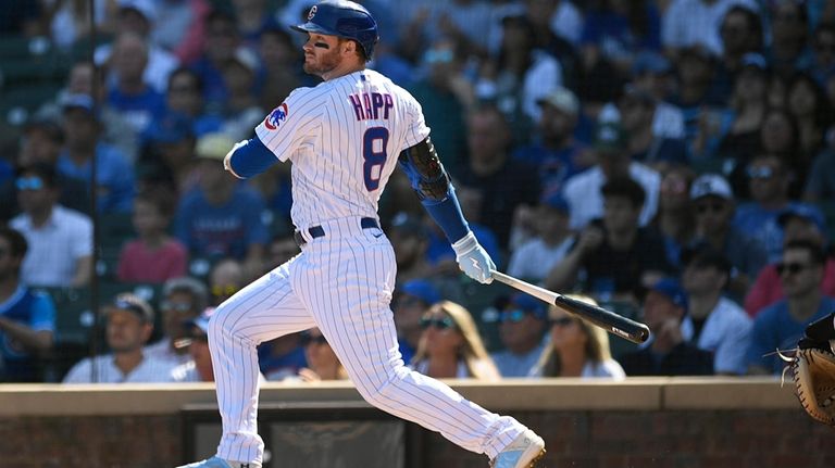 Chicago Cubs' Ian Happ watches his RBI double during the...