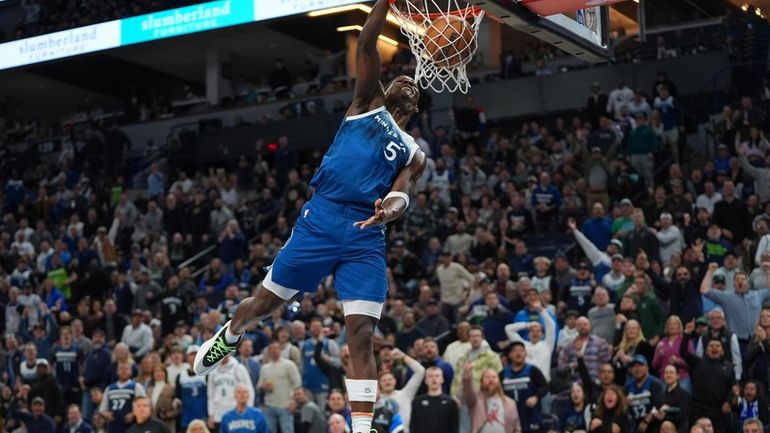 Minnesota Timberwolves guard Anthony Edwards dunks during the second half...