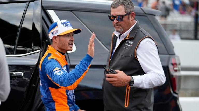 Kyle Larson waves to fans as he leaves following the...