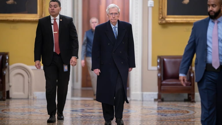 Senate Minority Leader Mitch McConnell, R-Ky., center, arrives as the...