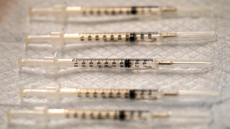 COVID-19 Pfizer-BioNTech vaccine syringes are seen at Edward Hospital in...