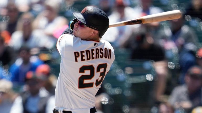 San Francisco Giants' Joc Pederson watches his two-run home run...