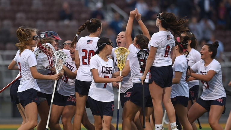 Cold Spring Harbor girls lacrosse teammates celebrate after their 14-1...