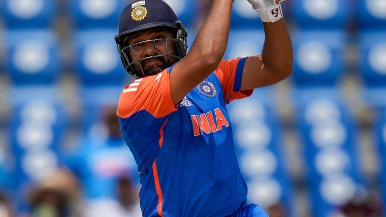 India's captain Rohit Sharma plays a shot for six runs...