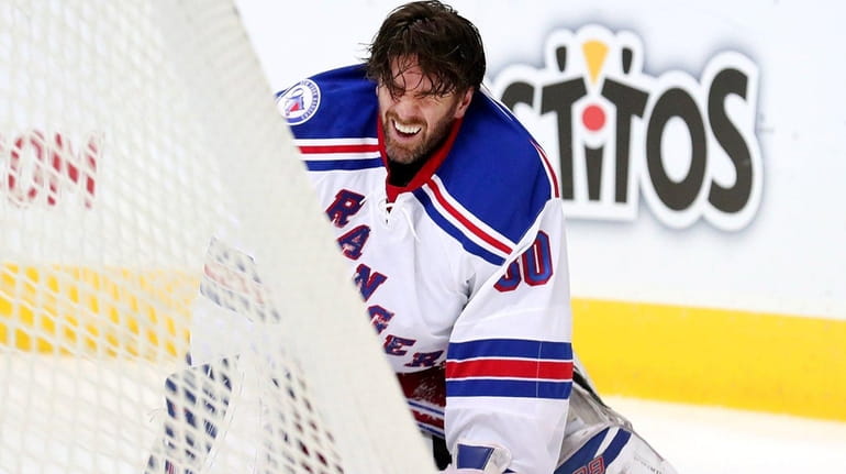 Henrik Lundqvist #30 of the New York Rangers reacts after...