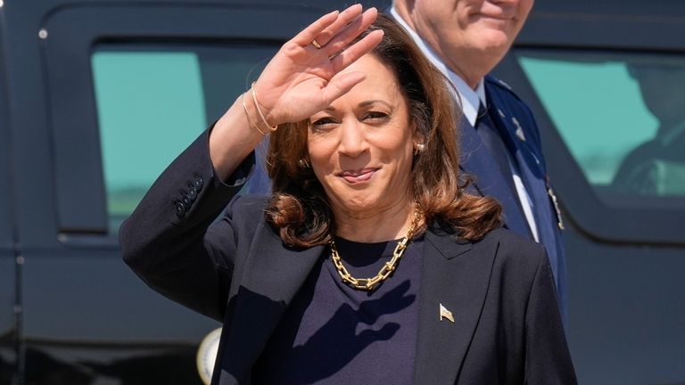 Democratic presidential nominee Vice President Kamala Harris waving to media...