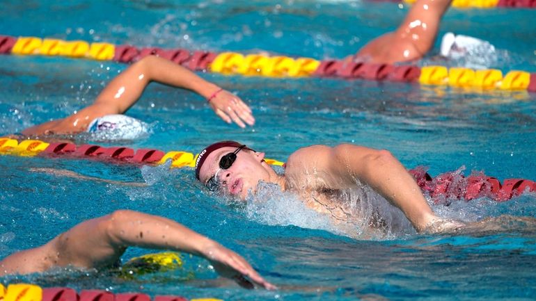 French Olympic swimmer Leon Marchand trains with his Arizona State...