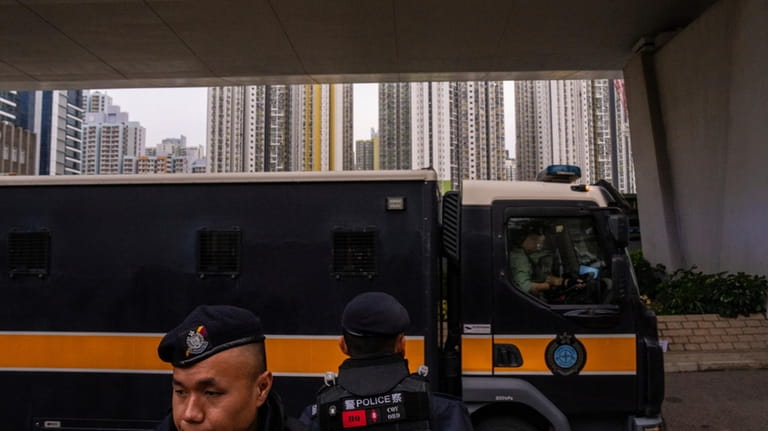 An armoured prison van carrying activist publisher Jimmy Lai' enters...