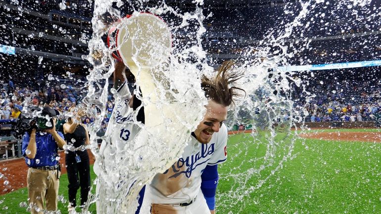 Kansas City Royals' Bobby Witt Jr., right, is doused by...