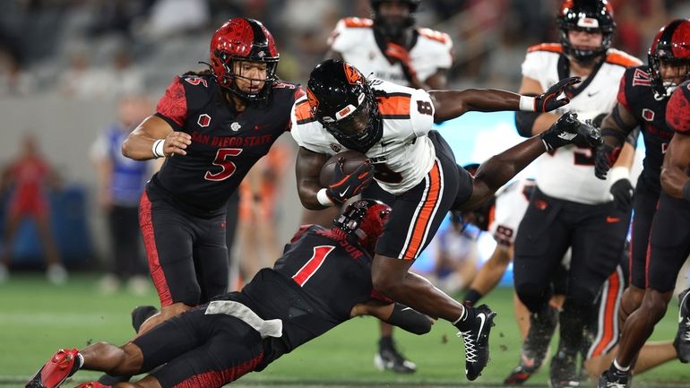 Oregon State running back Jam Griffin (8) is tackled by...