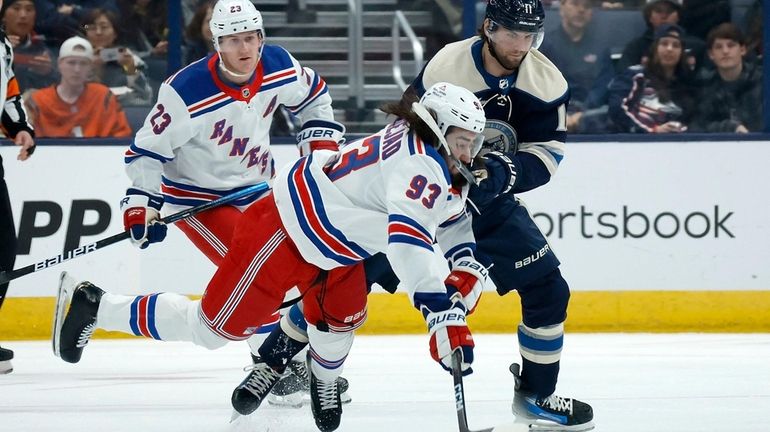 Mika Zibanejad #93 of the New York Rangers is knocked...