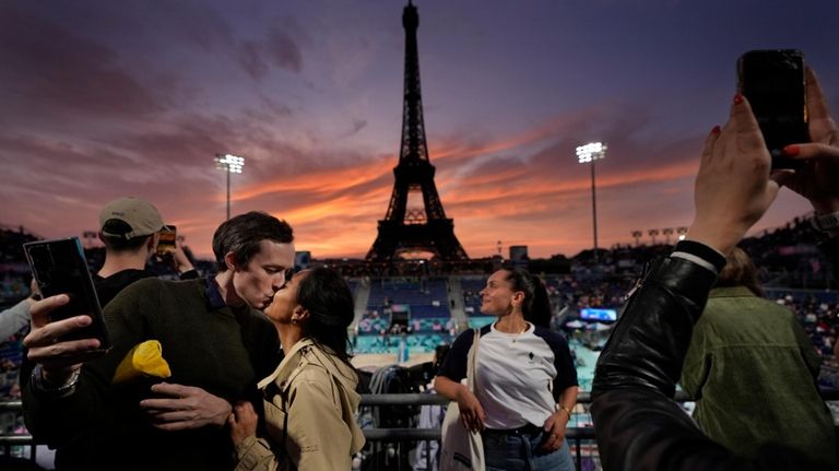 Maeva Ratoanina and Pierre-Yves Massive, of Paris, enjoy a romantic...