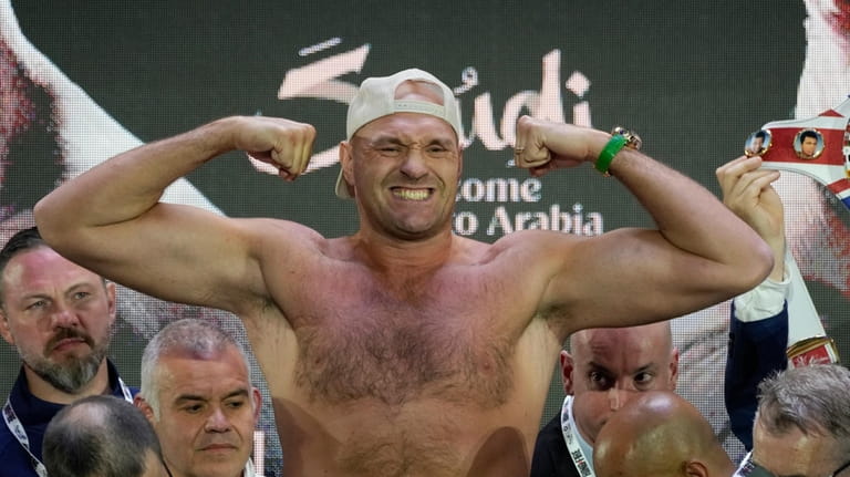 Heavyweight boxer Britain's Tyson Fury poses as he stands on...