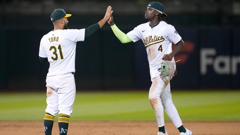 Oakland Athletics' Abraham Toro, left, celebrates with Lawrence Butler after...