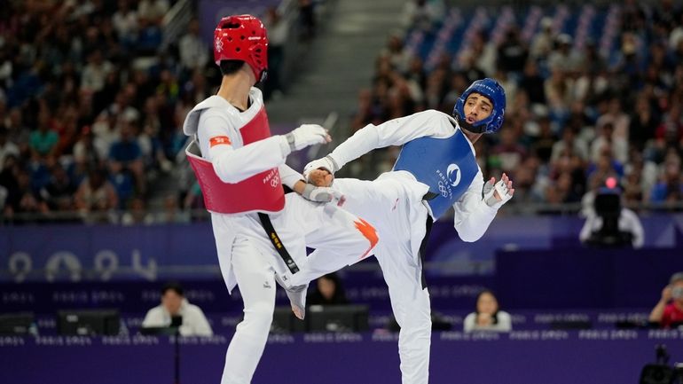 Hong Kong's Lo Wai Fung competes with Refugees Olympic Team's...