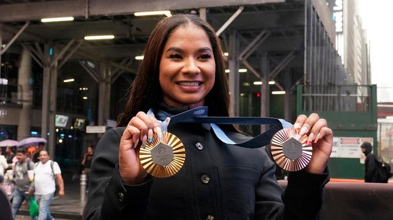 Two-time U.S. Olympic gymnast medalist Jordan Chiles shows her medals...