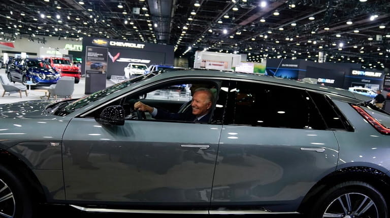 President Joe Biden drives a Cadillac Lyriq through the show...