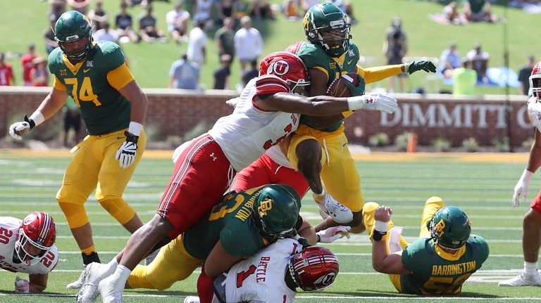 Baylor wide receiver Hal Presley (16) is tackled Utah linebacker...