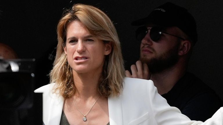 Tournament director Amelie Mauresmo watches Poland's Iga Swiatek and Italy's...