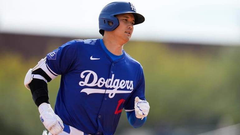 Los Angeles Dodgers designated hitter Shohei Ohtani runs the bases...