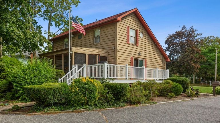 Priced at $609,000 this three-bedroom, two-bath log-style home on Peconic...