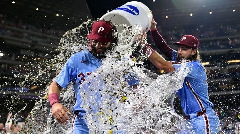 Philadelphia Phillies' Weston Wilson, center, is doused by teammates Brandon...