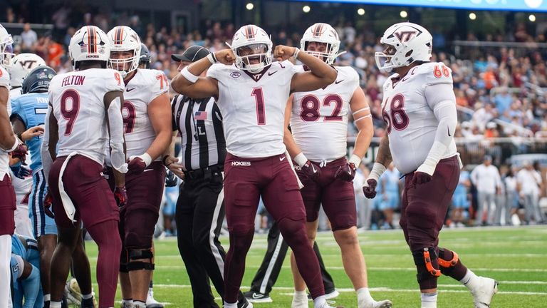 Virginia Tech quarterback Kyron Drones (1) celebrates after scoring a...